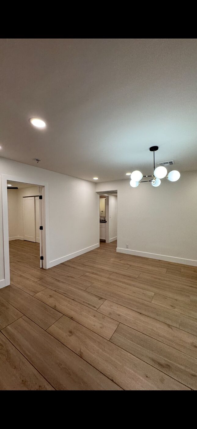 Modern interior with hardwood floors and recessed lighting