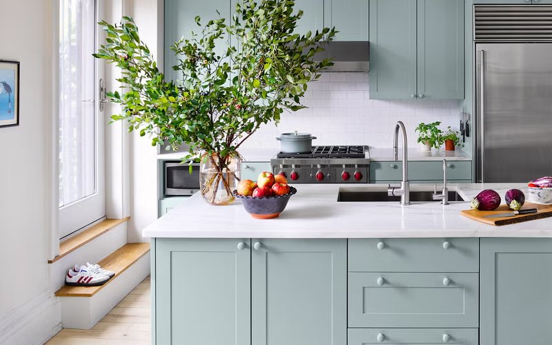 Freshly refinished pale-blue kitchen cabinets