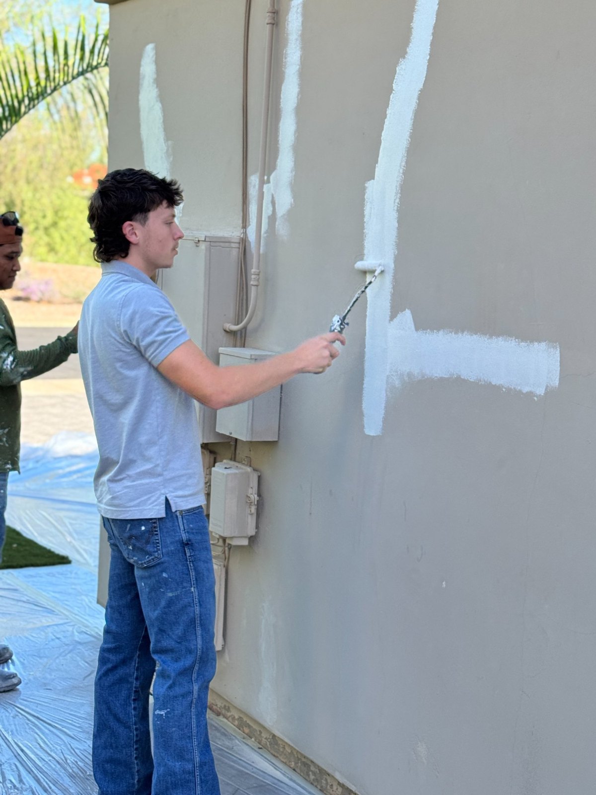 SLW Painting crew member rolling a wall